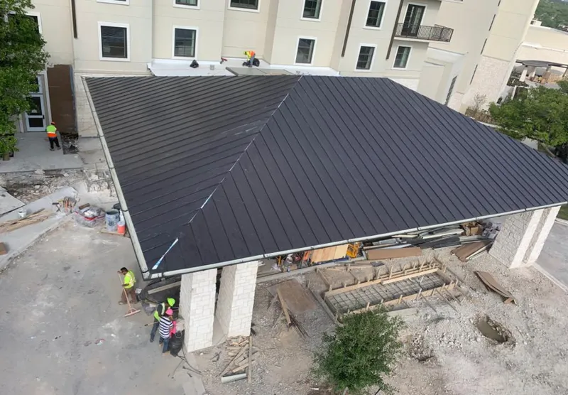 Metal roofing installation team working on a commercial building in Bay Village